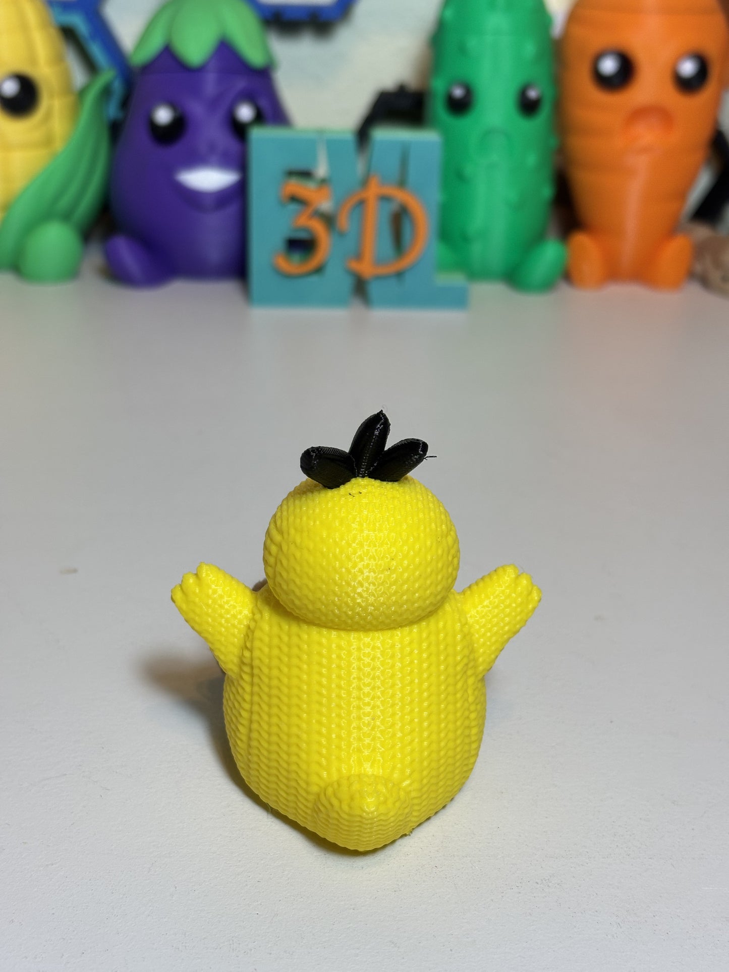 3D printed Psyduck sculpture gift displayed on shelf with plants