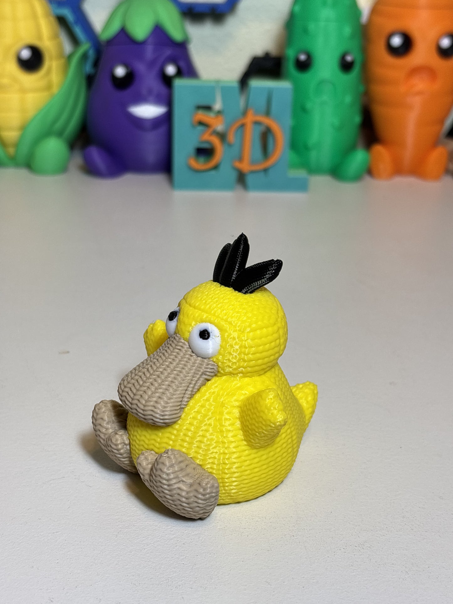 Faux knit Psyduck 3D printed decorative statue on wooden desk