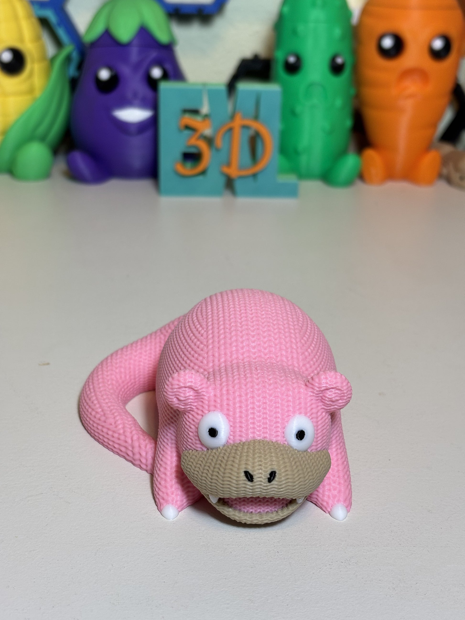 Faux knit SlowPoke statue displayed on shelf among pop culture decor