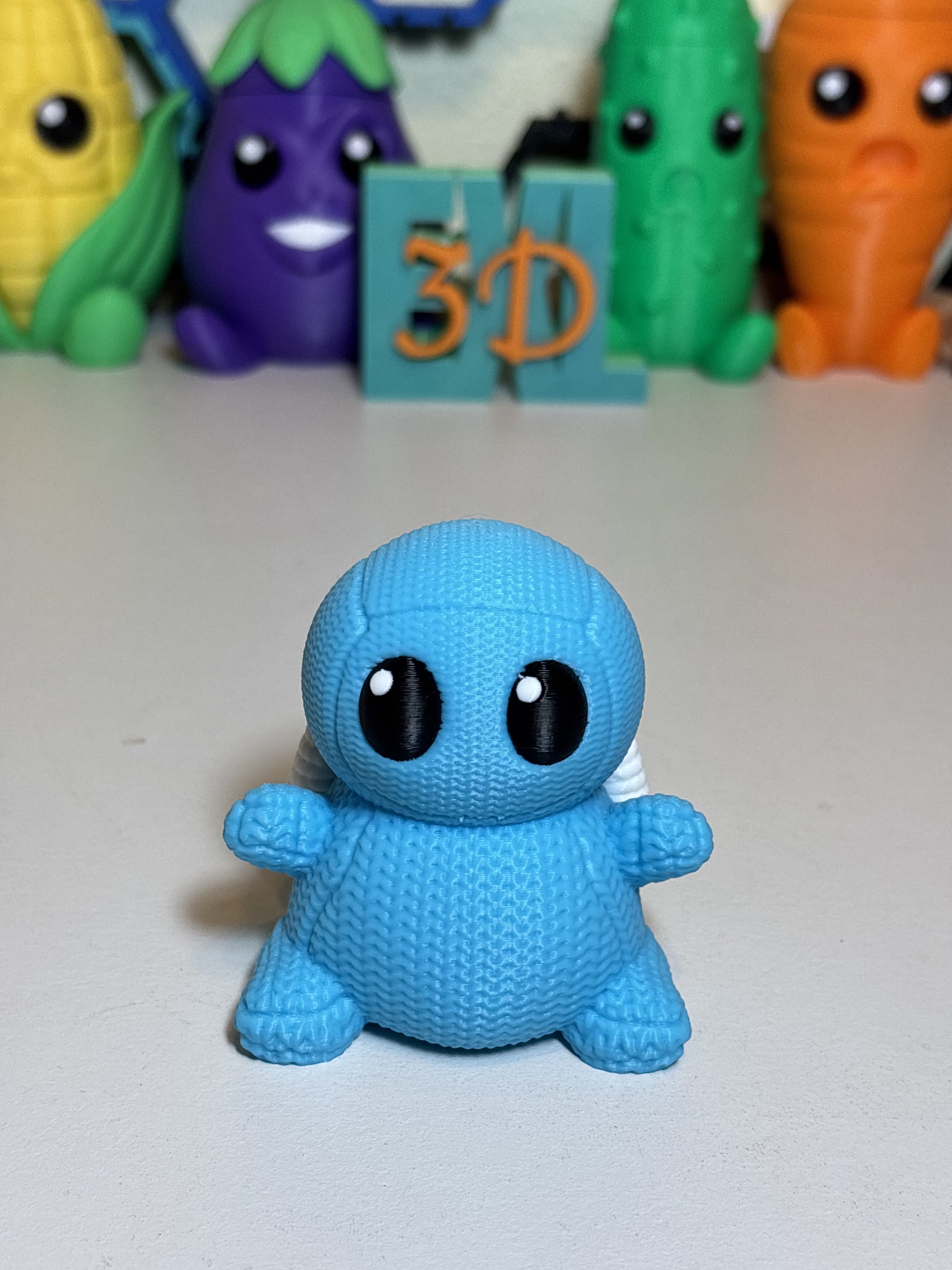 Faux knit Squirtle decorative sculpture shown on shelf with plants