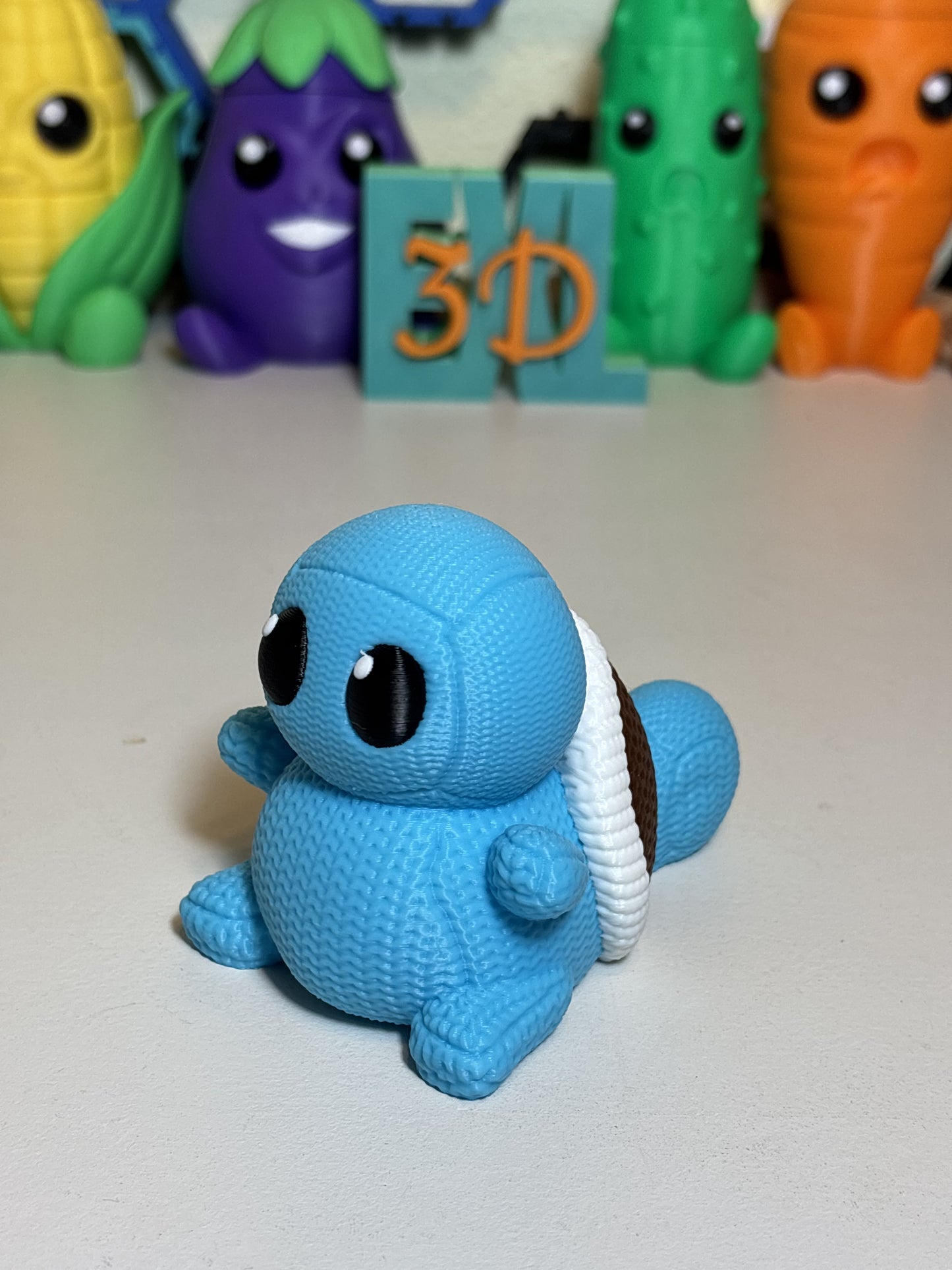 Faux knit Squirtle 3D printed statue on wooden desk close-up