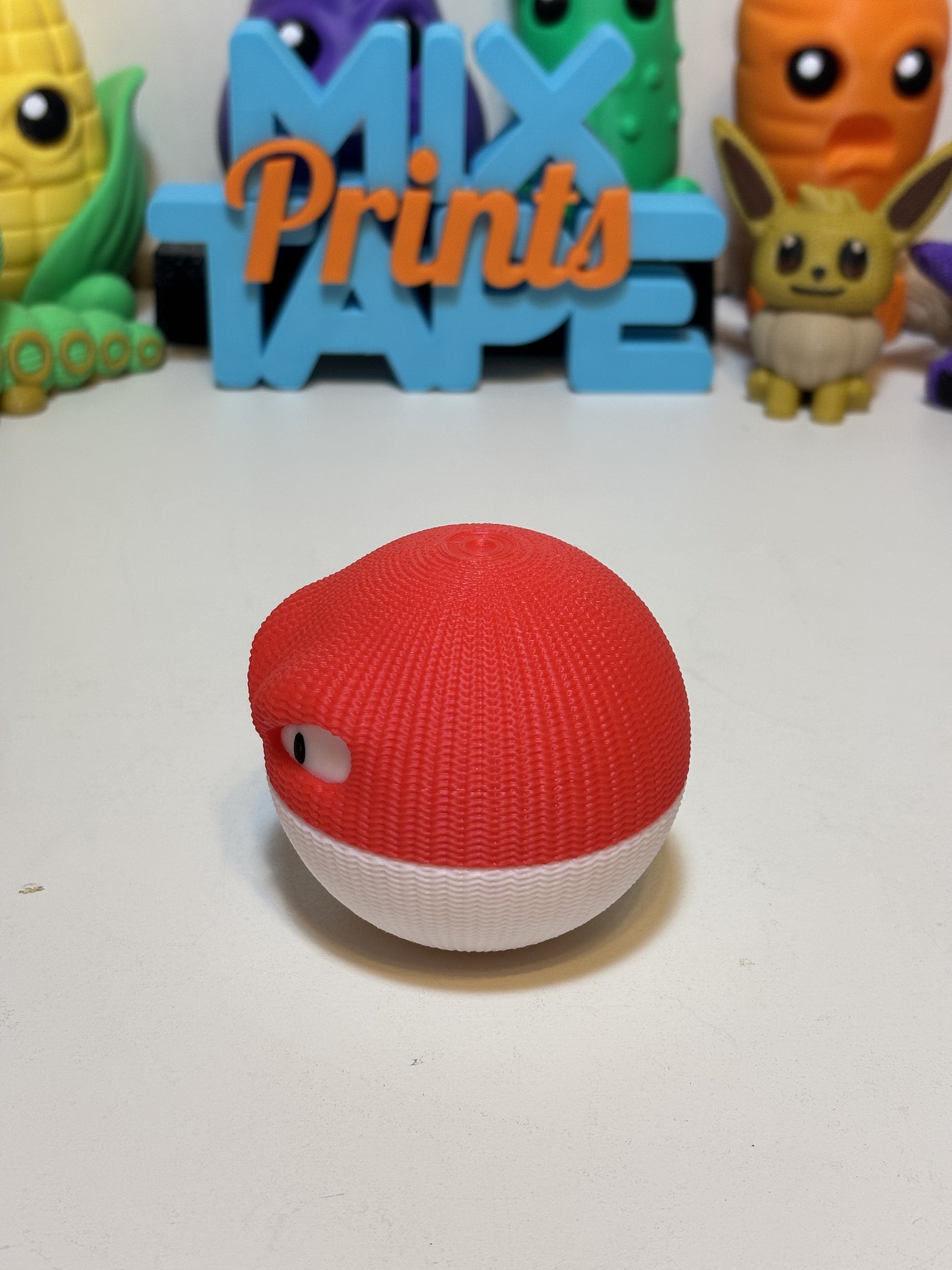 3D printed Voltorb figurine side angle showing sculpted knit detail