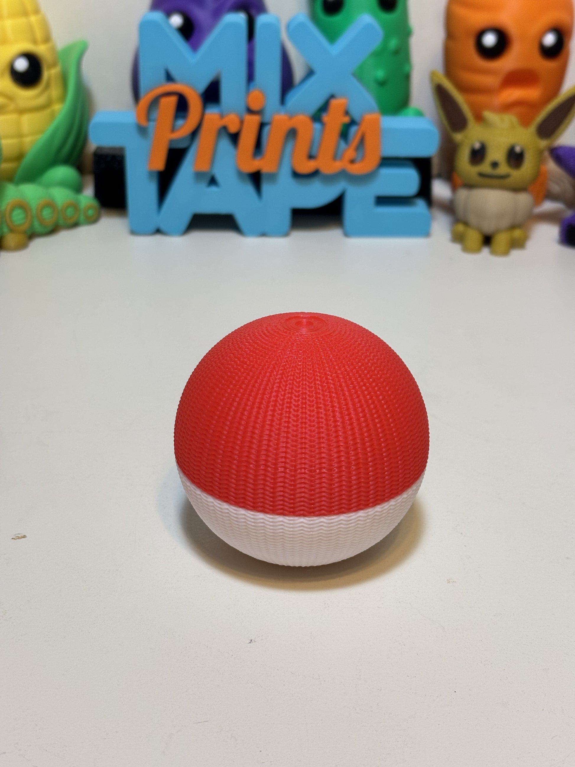 Voltorb faux knit statue next to gaming setup as desk decor gift