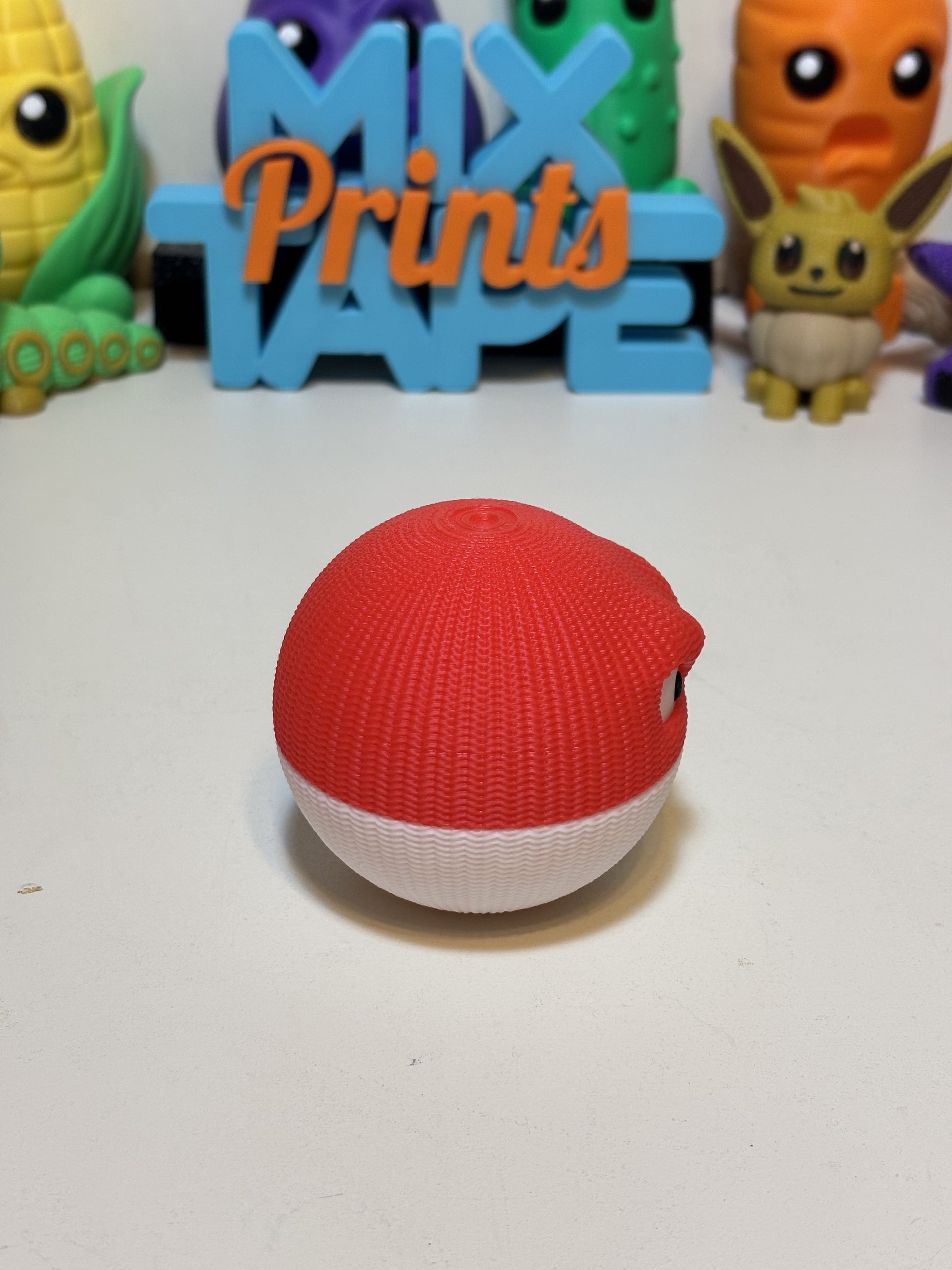 Top-down view of 3D printed Voltorb figure showing round knit texture