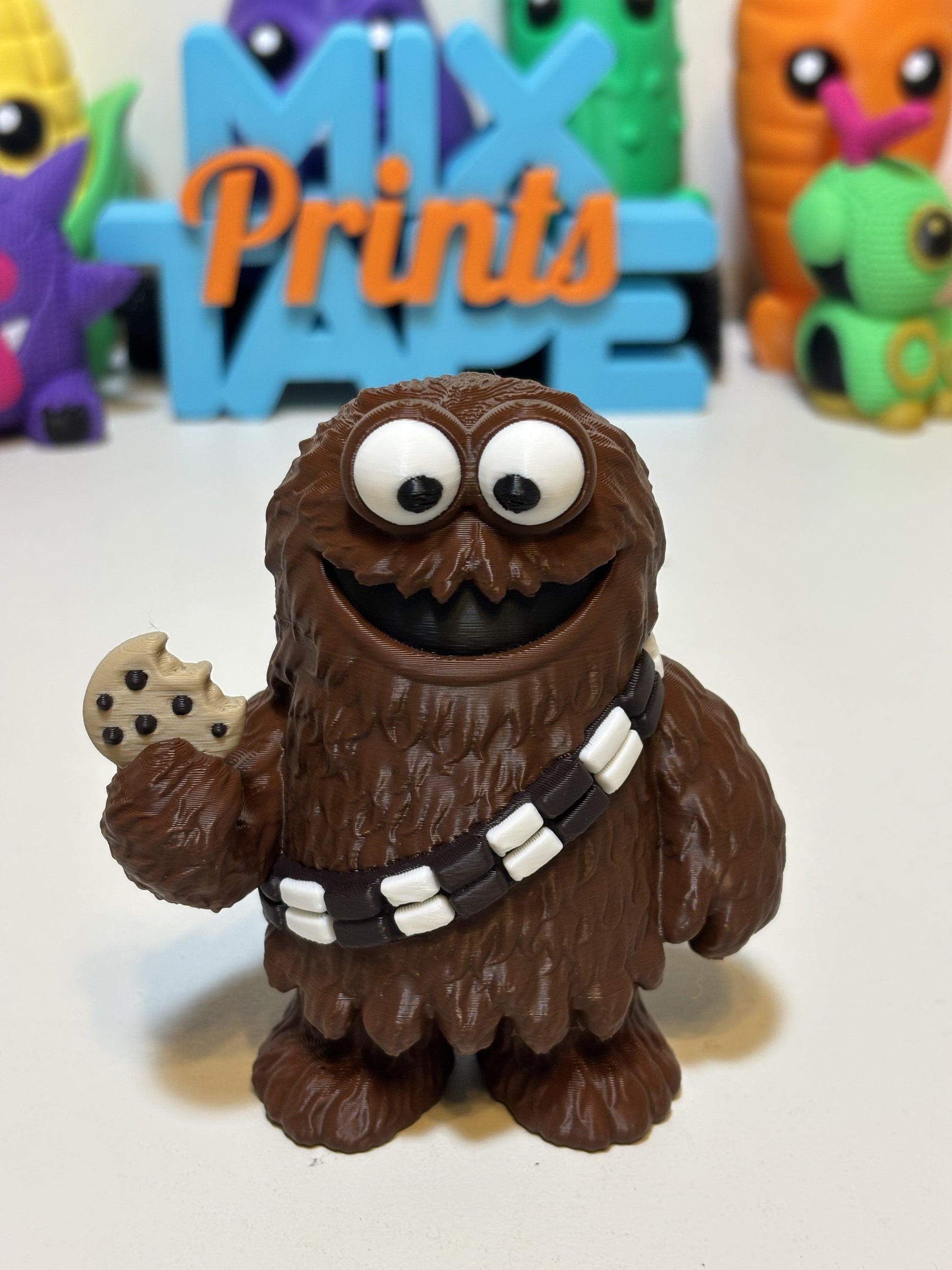 Wookiee Monster figure sitting on gamer desk beside keyboard and gaming accessories