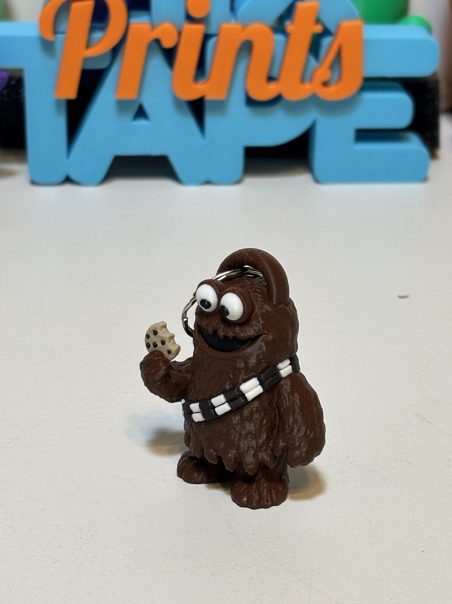 Wookiee Monster keychain version in brown PLA next to standard size figure for scale