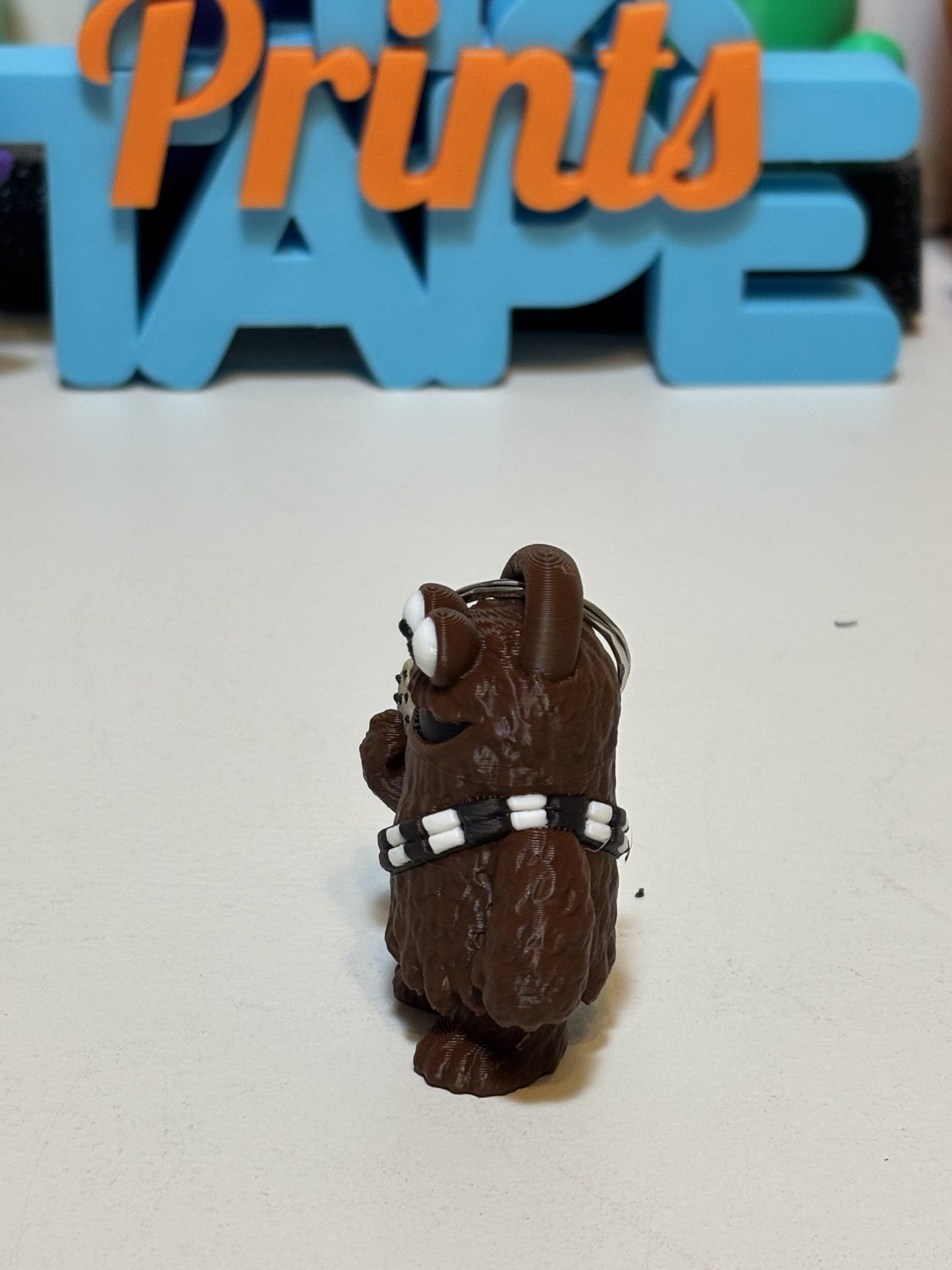 Overhead flat lay of Wookiee Monster figure with sci-fi themed desk props